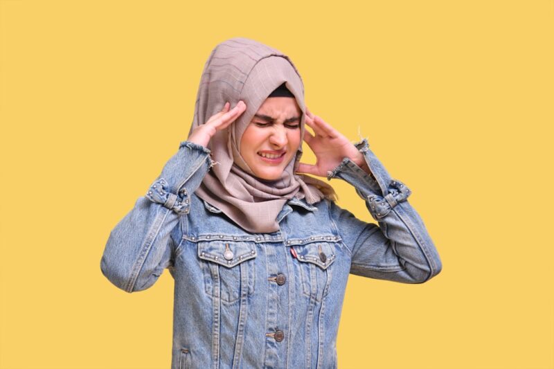 a woman wearing a hat and holding her hands up
